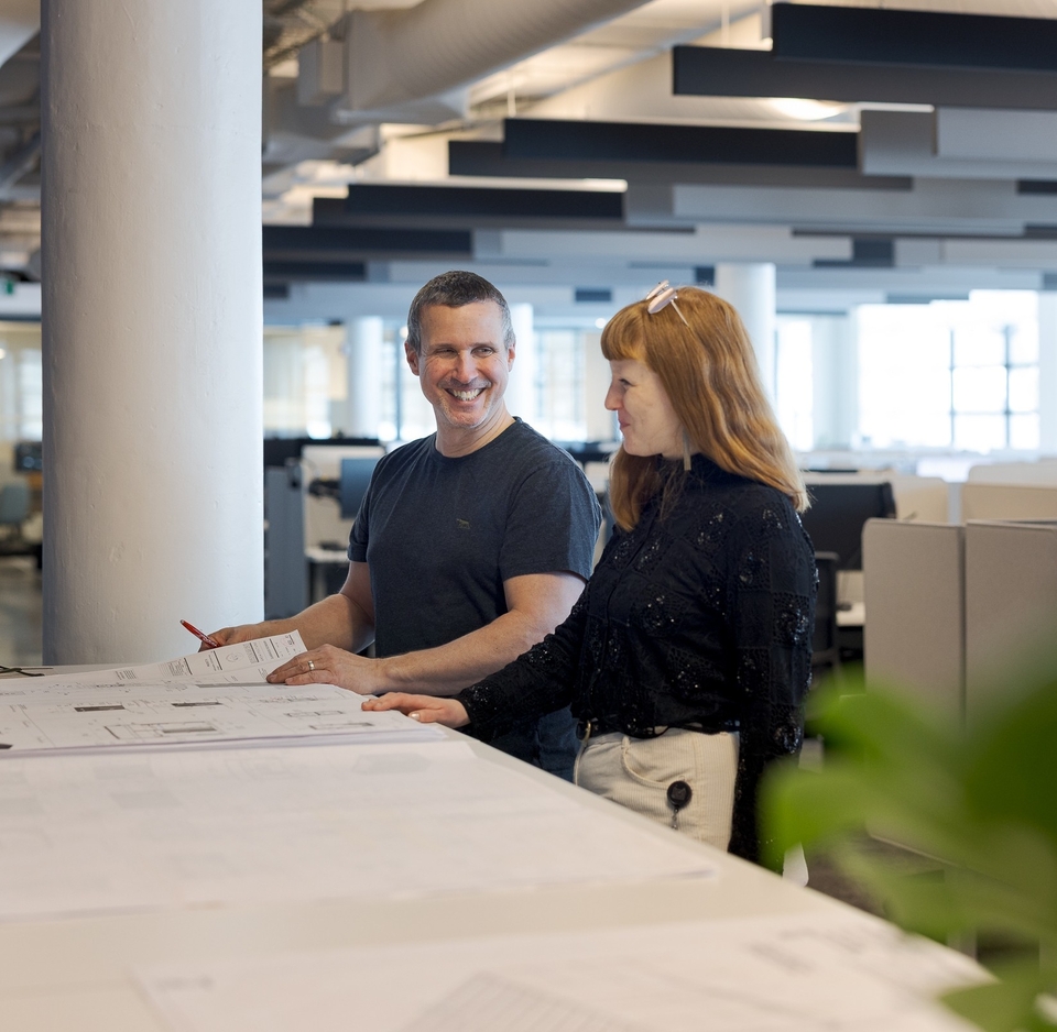 Two colleagues looking at a plan.